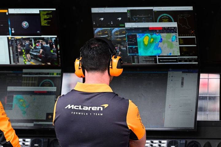A McLaren engineer takes a look at the weather radar on the pit wall