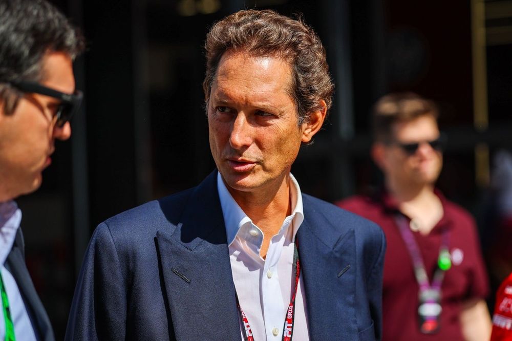 Ferrari chairman John Elkann looks on in the paddock.