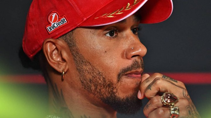 Lewis Hamilton looks tense as he holds his hand to his chin
