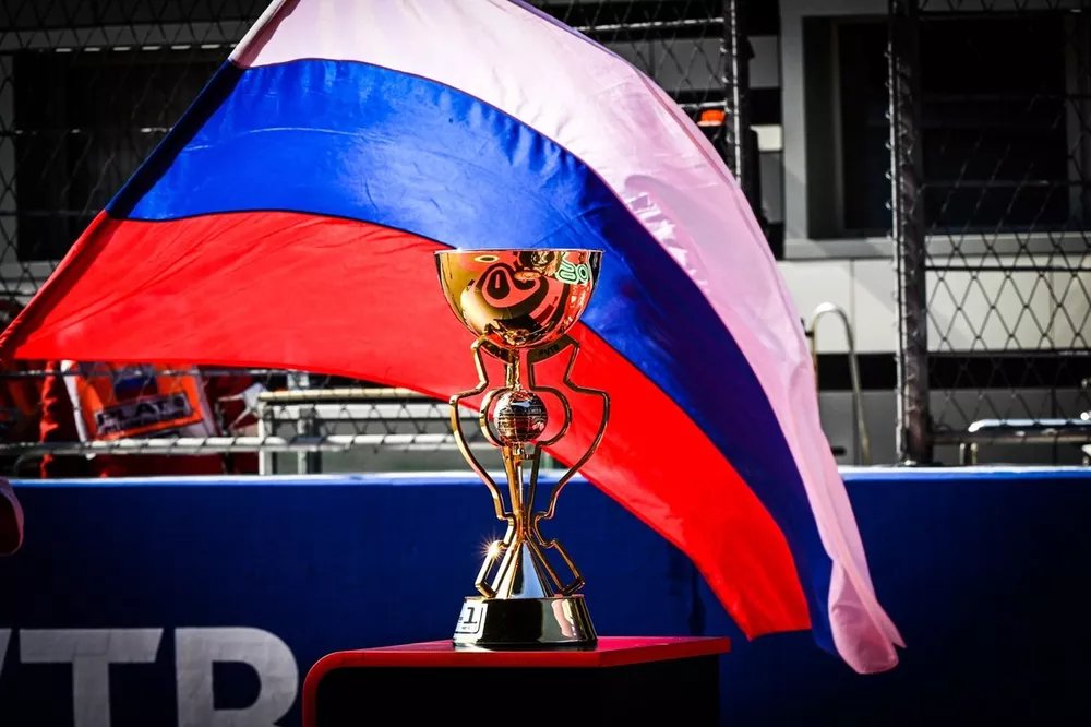 The trophy and a Russian flag on the grid