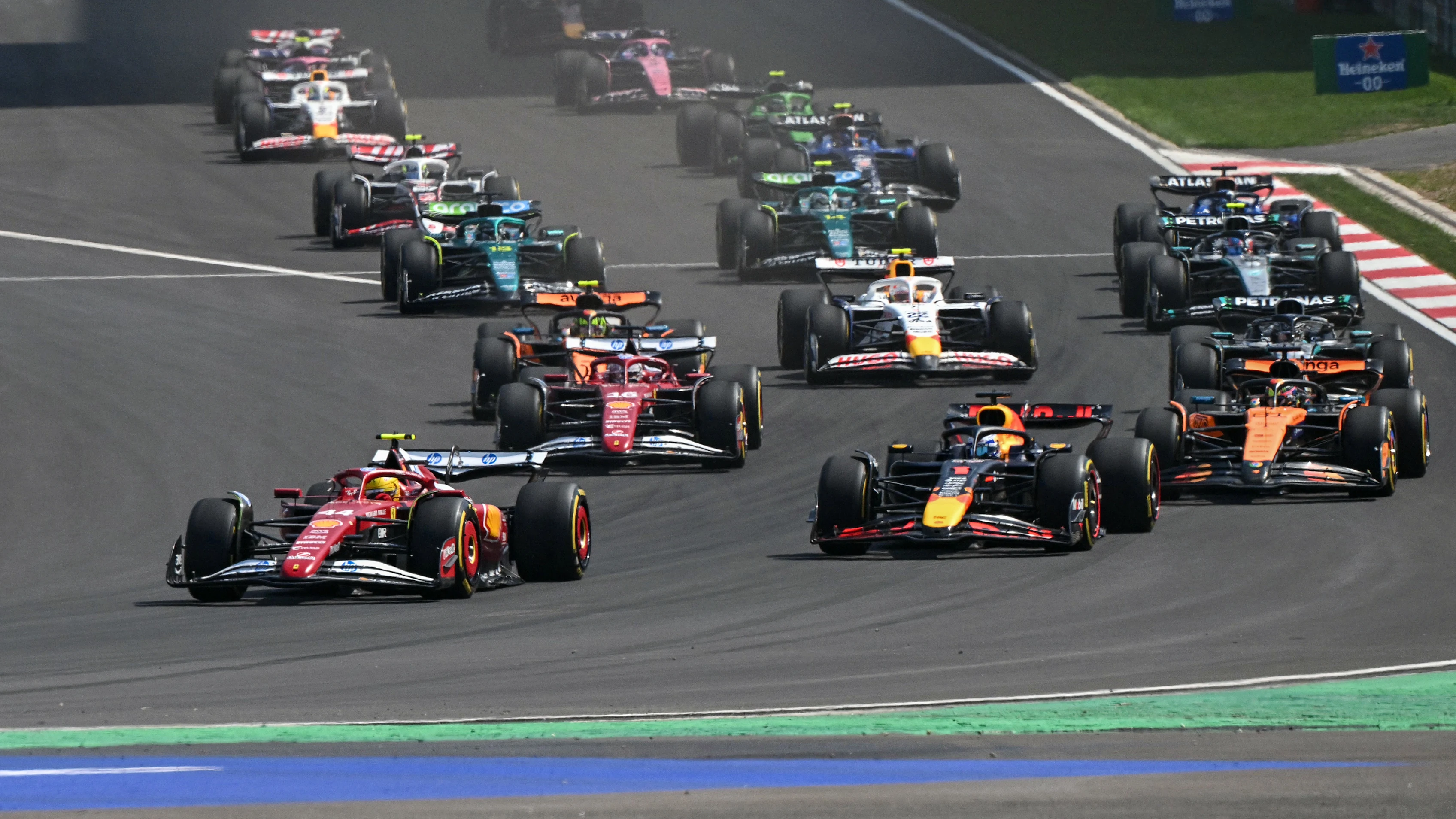 Ferrari's British driver Lewis Hamilton (front L) leads the pack at the start of the sprint race of