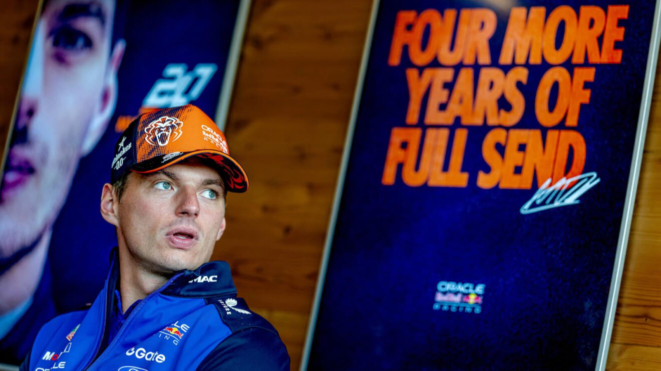 Max Verstappen sitting in front of the Red Bull board announcing his four years 'full send'